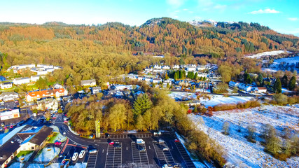 Low level aerial footage of the village of Aberfoyle in Scotland.