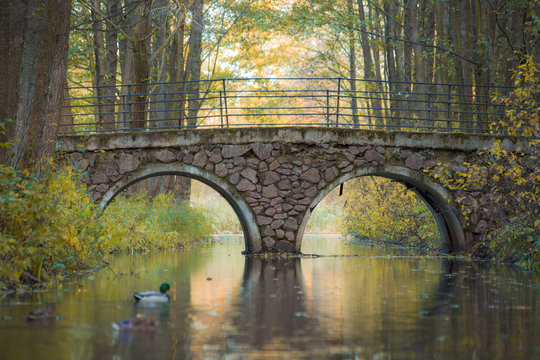Beautiful scenery in Belarus. Magnificent autumn in the European city. A beautiful bridge across the river autumn.