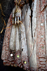 Detail of balinese wooden sculpture, hand and skirt, old decayed wood