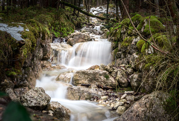 Waterfall in Bavarian forrest between trees, long exposure, landscape and nature