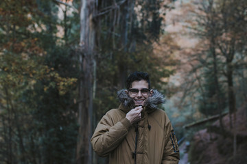 Fototapeta premium portrait of young man in the forest in autumn or winter