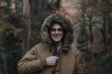 portrait of young man in the forest in autumn or winter