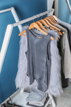 Collection of clothes hanging on rack in dressing room