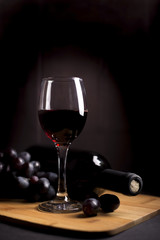 wine chalice and grapes on the wood