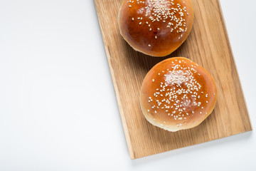Burger bread bun isolated on white background. Top flat view, from above.