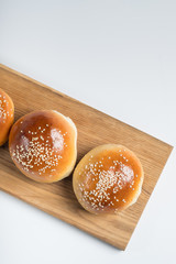 Burger bread bun isolated on white background. Top flat view, from above.