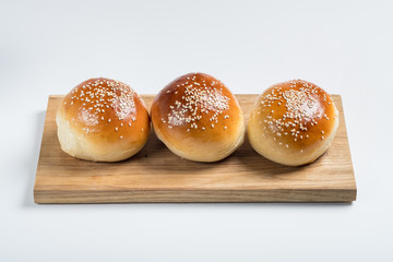 Burger bread bun isolated on white background. Top flat view, from above.