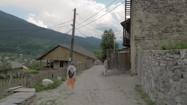 Girl walks in the old city Mestia, Georgia