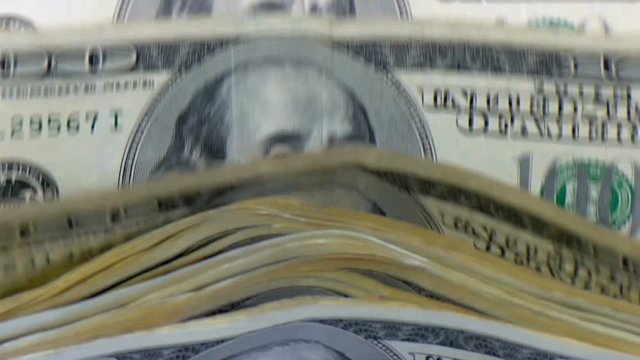 Money counting machine counts 100 dollar bills. Slow motion close up front shot