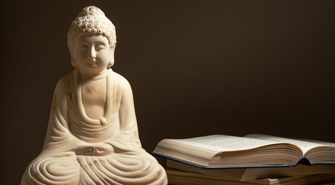 Buddha statue with books.