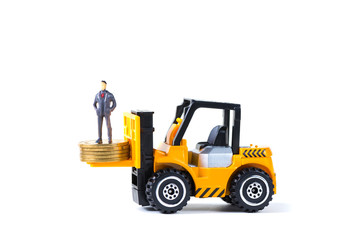 Mini forklift truck loading stack coin with steps of gold coin, isolated on white background with copy space, business finance and banking industrial concept.