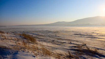 The frozen River Amor and the border fence between China and Russia [China side] near the corner of the Jewish Oblast, Khabarovsk and Heilongjiang Province