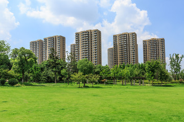 Obraz premium urban suburban apartment buildings and green park lawn