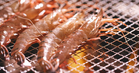 Barbecue with shrimp on metal net