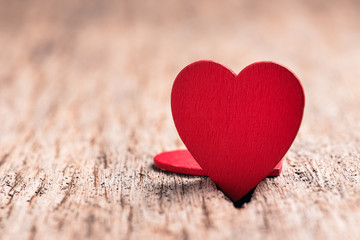 Naklejka na ściany i meble Red heart made from wood on wooden background