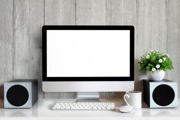 Mock up : Workspace with blank white desktop computer, pencils and stationery items. Blank screen for graphics display montage.