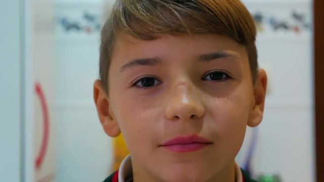 The boy blinks his eyes