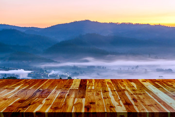 wooden floor and orange sky at sunset or sunrise time.