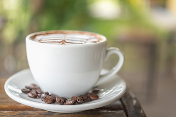 White coffee mug on patterned old wooden floor.