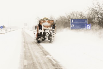 Snow plow removing snow from city road