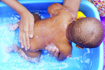 Baby Having Bath In Baby Bath Tub