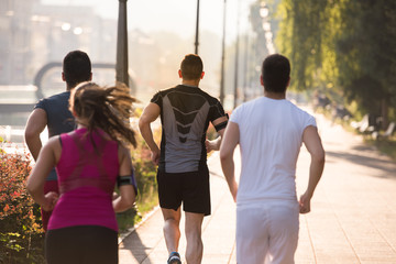 group of young people jogging in the city