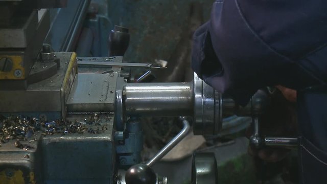 worker manages a metal working machine working on industry machine
