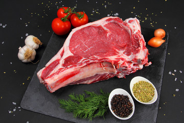 Raw Steak Beef on the Black Background