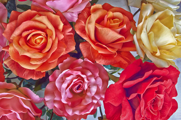 variety of colorful  fake roses, floral background