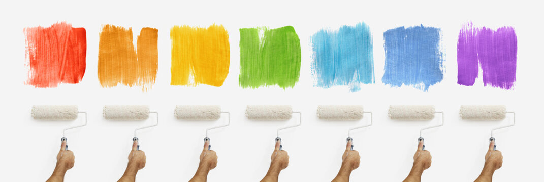 hand with roller paint on wall with colors samples, banner web template