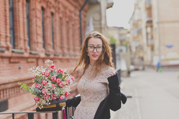 Spring walk of a girl with a flower bouquet