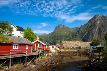 Fototapeta na wymiar Typical red rorbu fishing hut in town of Svolvaer