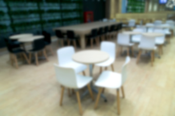 Fototapeta na wymiar Blur photo Empty table and chair in canteen, cafeteria interior