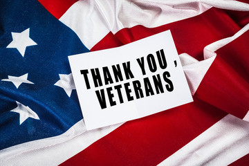 Fototapeta na wymiar Veterans day greeting card on flag