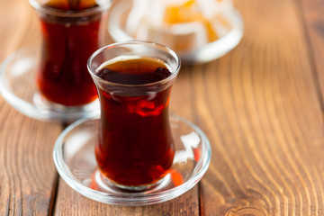 Red tea in turkish glasses on a wooden table