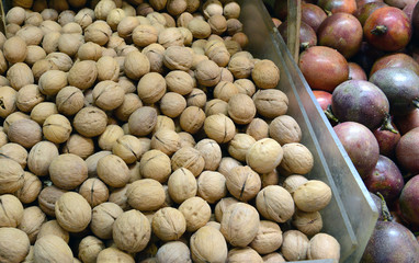 Street food with longans or dragon eye fruit among various fresh vegetables for sale at Asian market in China