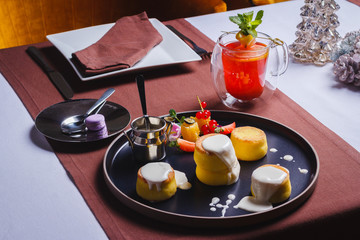 cheese pancakes with sour cream and fruit with tea