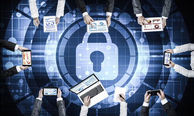 Top view of businesspeople sitting at table and using gadgets