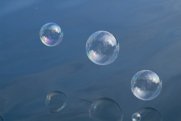 Soap bubbles over water