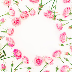 Round frame made of pink roses, branches and buds on white background. Flat lay, Top view. Valentines day composition