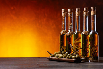 Olives and bottles of olive oil .