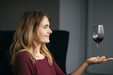 Attractive woman drink red wine in the restaurant
