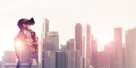 Guy wearing checked shirt and virtual mask holding hand on chin