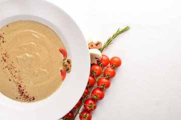 Mushroom puree soup. On a wooden background. Free space for your text. Top view.
