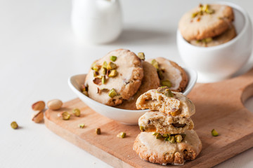 Butter cookies with pistachios on wooden board