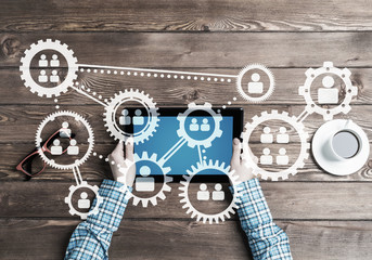 Concept of teamworking and connection with gears mechanism and tablet pc