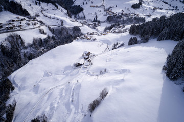 Obraz premium aerial flight with drone over coniferous forest in winter in austria in salzburg