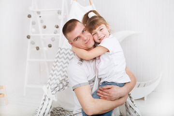 Obraz premium happy daughter hugging father in the kid bedroom. Happy family spending time at home.