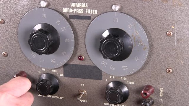 Connecting cables powering up and making frequency cut-off adjustments to variable band-pass filter vintage electronic hardware engineering military equipment