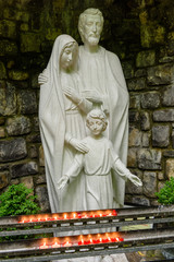 Grotto  with statues of the Virgin Mary, Saint Joseph, and the child Jesus, with lit candles, at the Tobarnalt Holy Well, County Sligo, Ireland